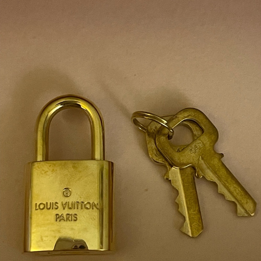 LV Louis Vuitton purse lock with keys. Gold-tone in color.